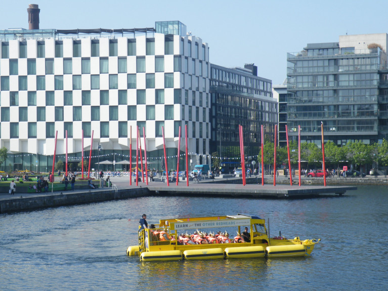 A Viking Splash tour amphibious vehicle 'Duk' sails around Dublin’s Grand Canal Dock (as above in Afloat 's photo) with the backdrop of the 'Docklands' quarter. 